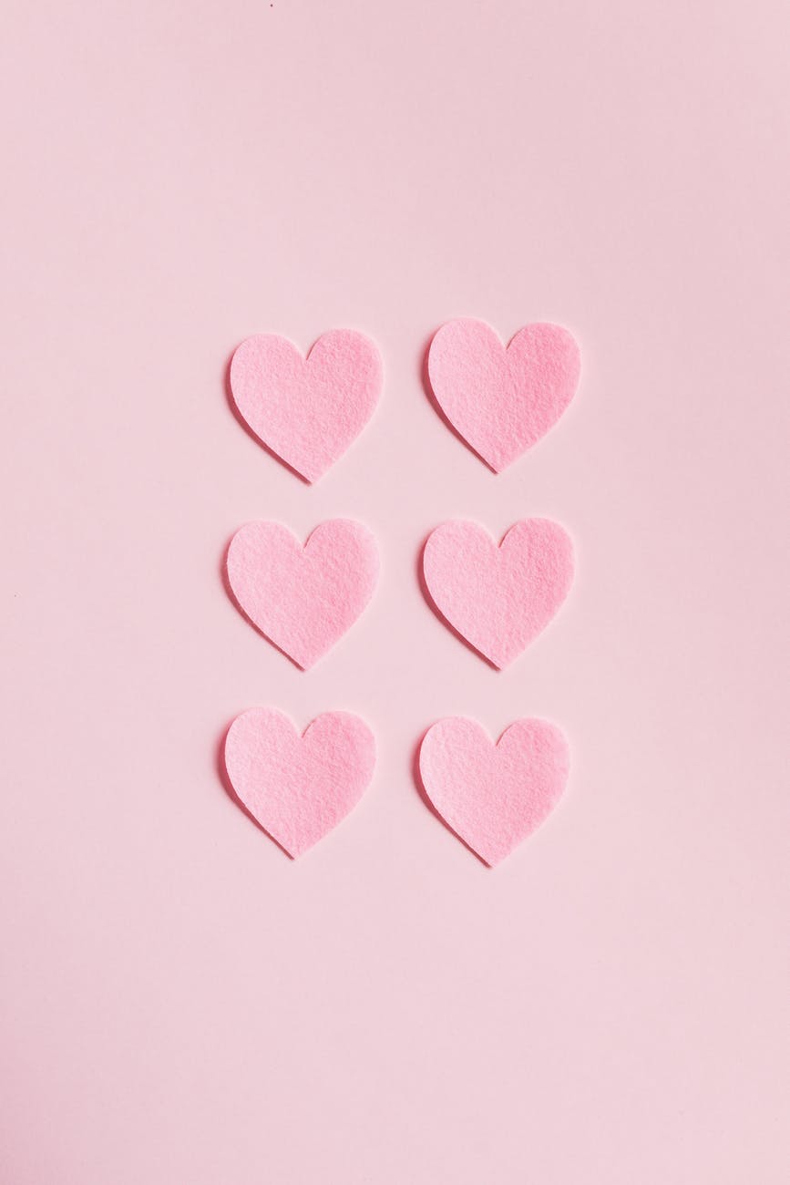 heart shaped cutouts on pink background