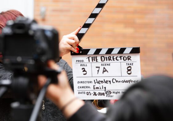 man holding clapper board
