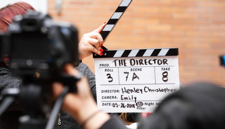 man holding clapper board