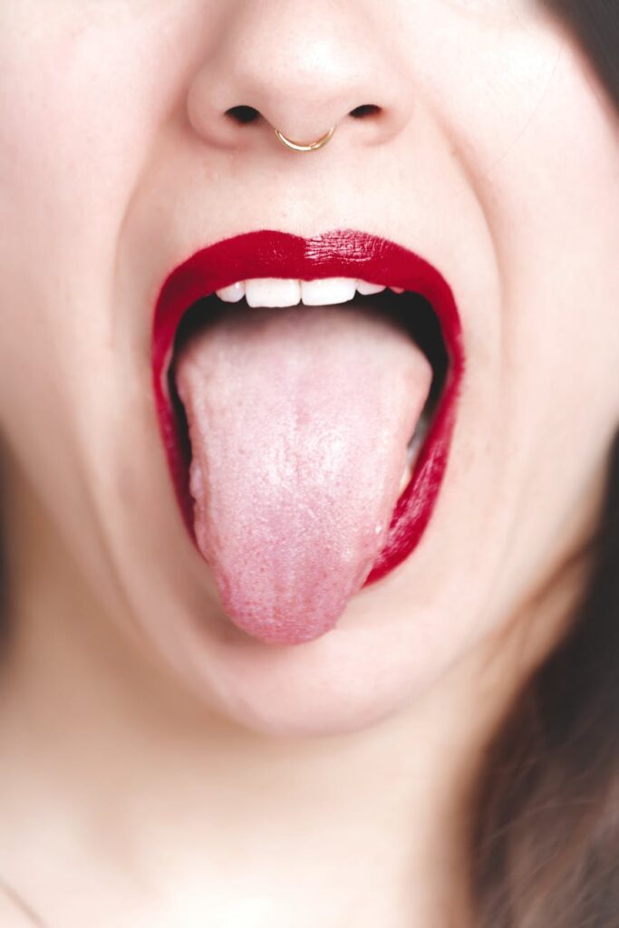 photo of woman showing her tongue