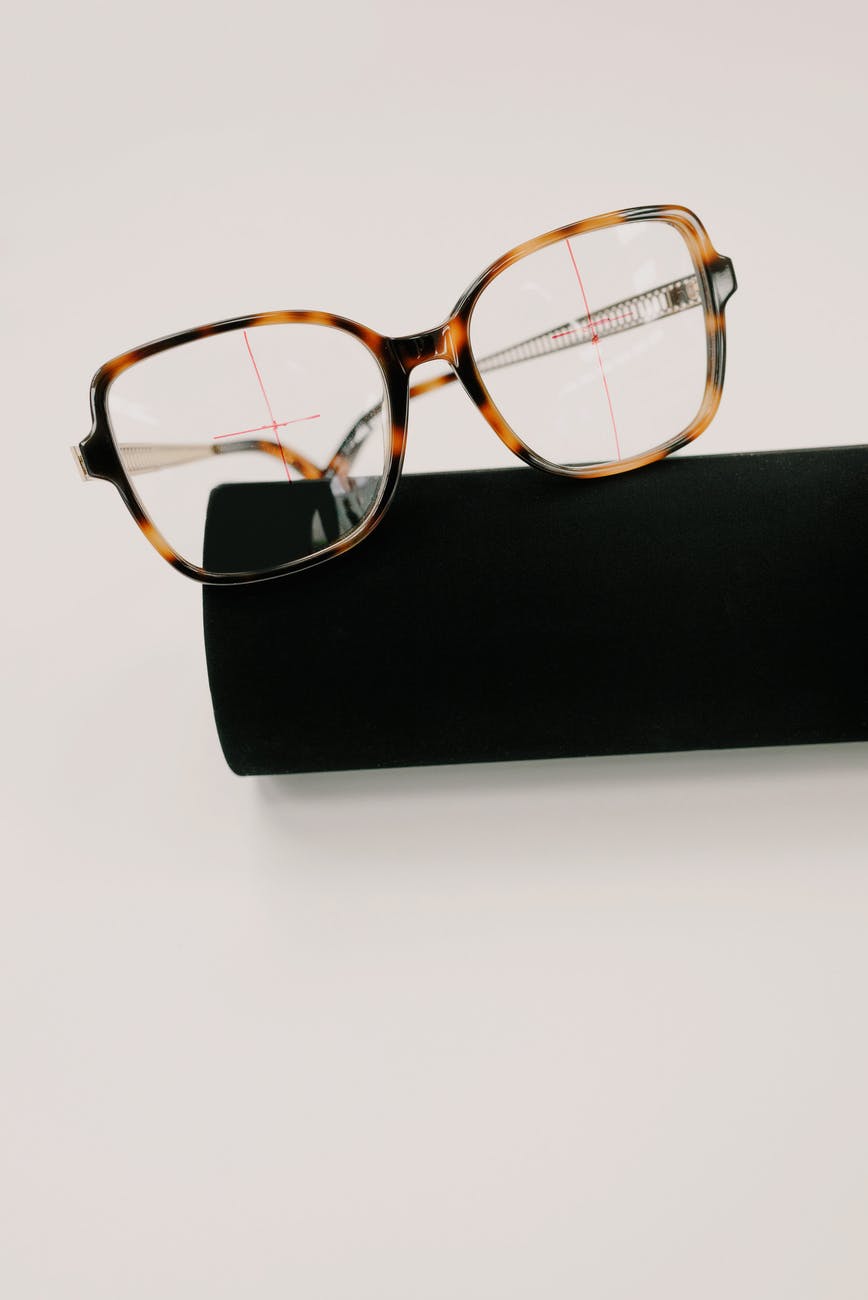 stylish eyeglasses with ornamental frame on case