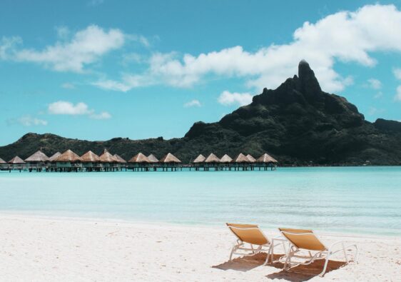 an island with cottages and beach chairs